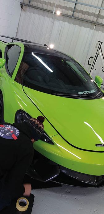 A repair is being carried out to a green Mclaren matching IMI standards and paid for via Payment Assist