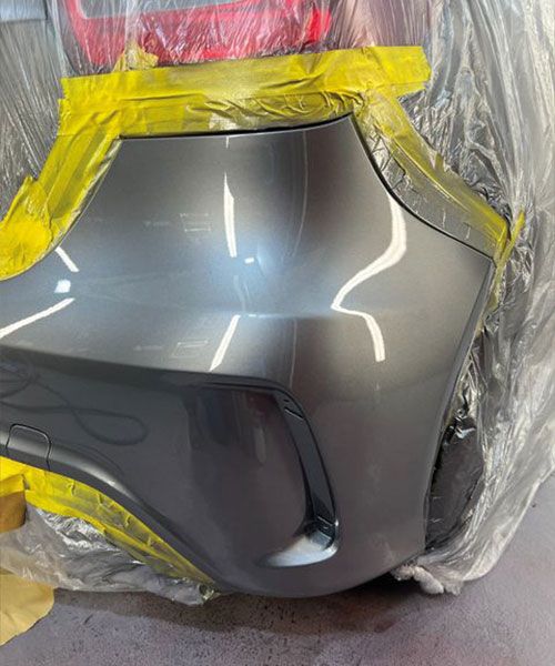 A grey/silver bumper section looking good as new following damage repair and paint at Them Paint Guys Vehicle Body shop in Pontardawe